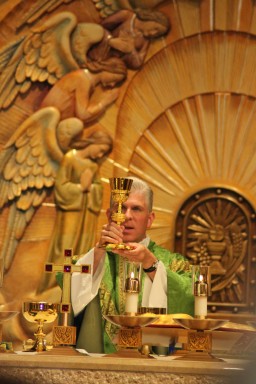 Priest elevating chalice at Mass