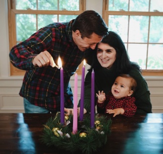 Photo of young family lighting the Advent Wreath